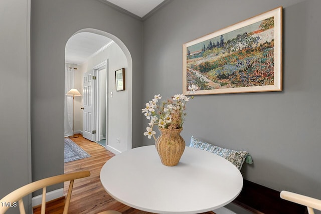 2504 State St, Durham, NC 27704 - dining space featuring ornamental molding, arched walkways, and wood finished floors