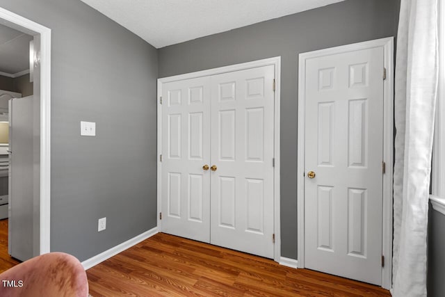 2504 State St, Durham, NC 27704 - bedroom with wood finished floors, a closet, and freestanding refrigerator