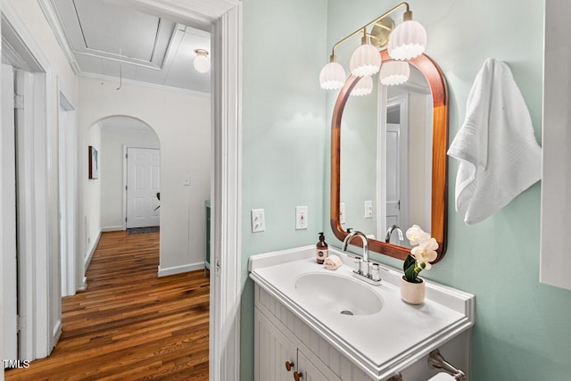 2504 State St, Durham, NC 27704 - bathroom featuring wood finished floors, crown molding, and vanity