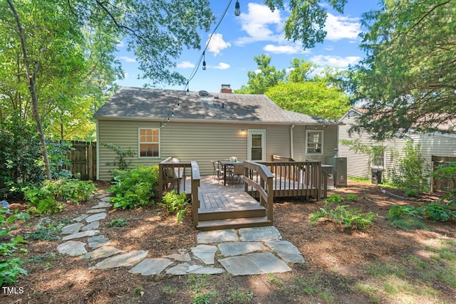 2504 State St, Durham, NC 27704 - rear view of property featuring a deck, a chimney, roof with shingles, and outdoor dining space
