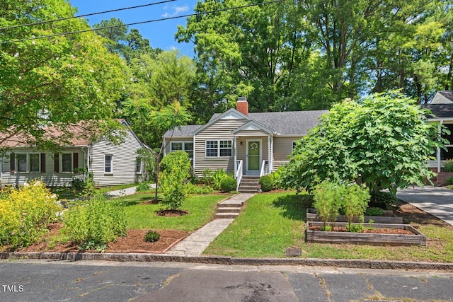 2504 State St, Durham, NC 27704 - view of front facade with a chimney, a front lawn, and a vegetable garden