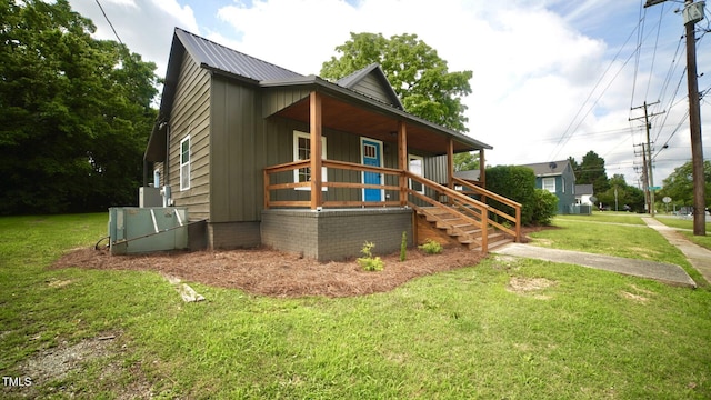 416 Everett St, Burlington, NC 27215 - view of front of home featuring a porch, a front yard, a metal roof, and stairway