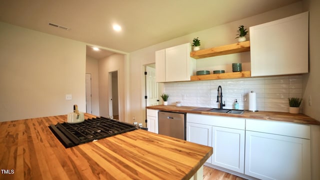 416 Everett St, Burlington, NC 27215 - kitchen with wooden counters, dishwasher, stovetop, tasteful backsplash, and white cabinetry