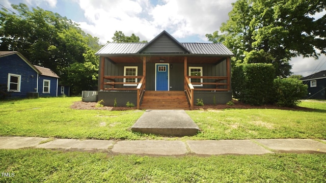 416 Everett St, Burlington, NC 27215 - bungalow with a porch, board and batten siding, a front lawn, and a metal roof