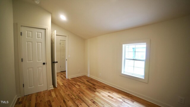 416 Everett St, Burlington, NC 27215 - unfurnished room featuring vaulted ceiling, light wood-type flooring, and a smoke detector
