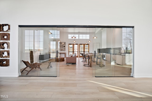 949 Cassa Clubhouse Way, Knightdale, NC 27545 - living room featuring light wood-style floors and a towering ceiling