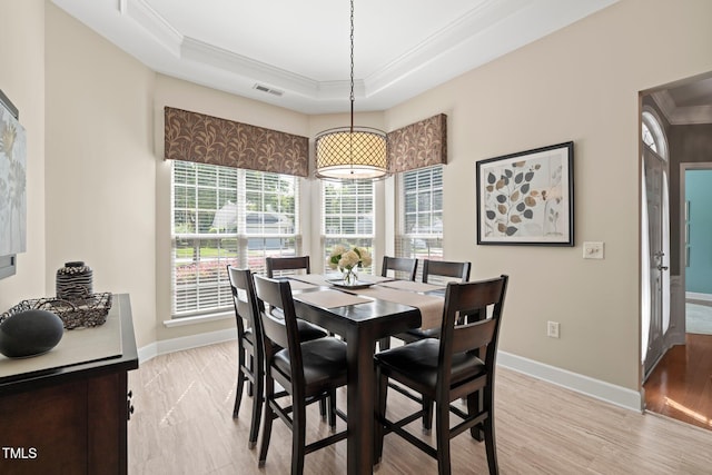 621 Aylestone Dr, Cary, NC 27519 - dining area featuring crown molding, a tray ceiling, and light wood-type flooring