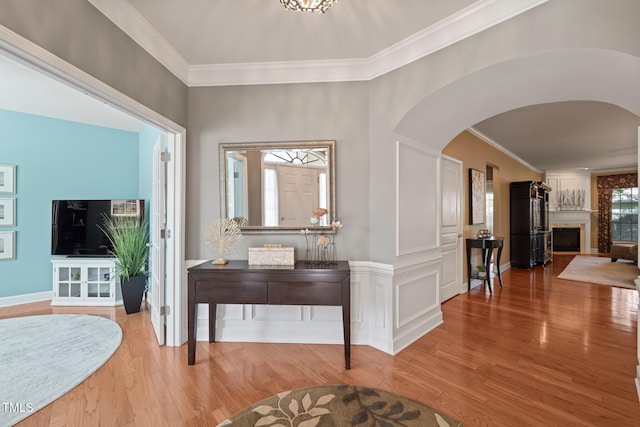 621 Aylestone Dr, Cary, NC 27519 - foyer entrance featuring arched walkways, wood finished floors, crown molding, and a fireplace