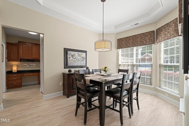 621 Aylestone Dr, Cary, NC 27519 - dining room featuring a tray ceiling, ornamental molding, light wood finished floors, and built in study area