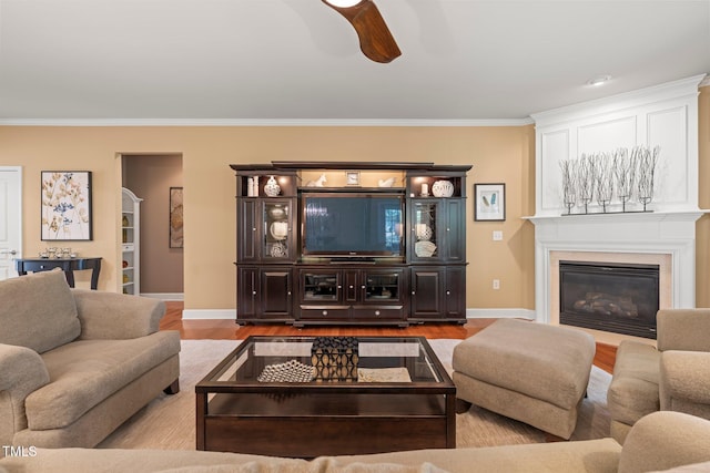 621 Aylestone Dr, Cary, NC 27519 - living area featuring wood finished floors, crown molding, a ceiling fan, and a glass covered fireplace