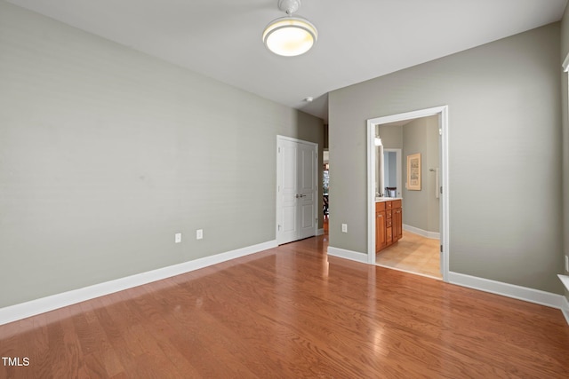 621 Aylestone Dr, Cary, NC 27519 - unfurnished bedroom featuring light wood-type flooring, a closet, and ensuite bathroom