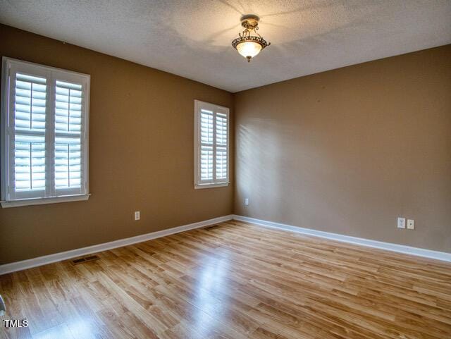 2817 Buckboard Ln, Raleigh, NC 27603 - empty room with light wood-style flooring and a textured ceiling