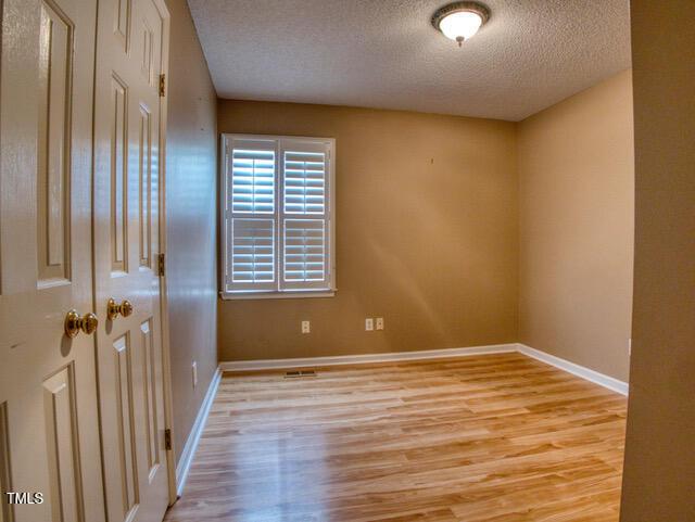 2817 Buckboard Ln, Raleigh, NC 27603 - spare room with a textured ceiling and light wood-type flooring