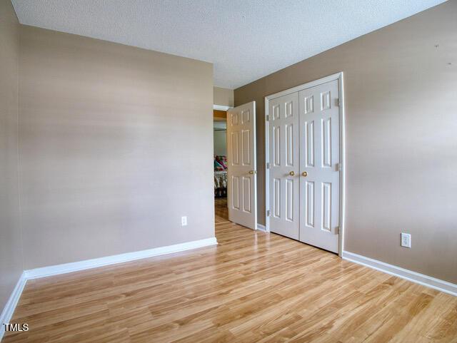 2817 Buckboard Ln, Raleigh, NC 27603 - unfurnished bedroom featuring light wood-type flooring and a closet