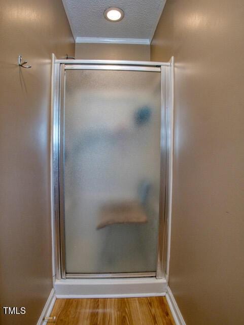 2817 Buckboard Ln, Raleigh, NC 27603 - full bath featuring a stall shower, crown molding, wood finished floors, and a textured ceiling