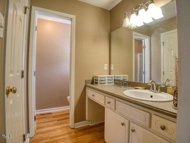 2817 Buckboard Ln, Raleigh, NC 27603 - bathroom with vanity and wood finished floors