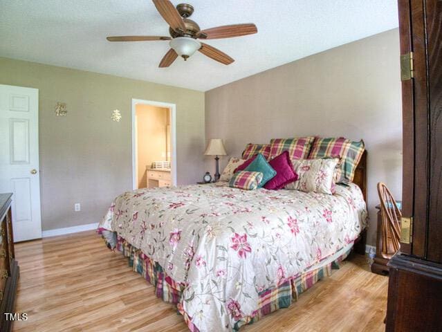 2817 Buckboard Ln, Raleigh, NC 27603 - bedroom featuring light wood-style floors, a ceiling fan, and ensuite bath