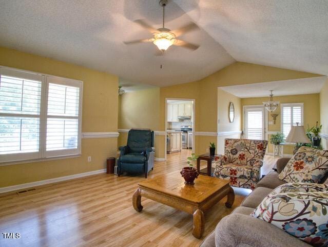2817 Buckboard Ln, Raleigh, NC 27603 - living area featuring light wood-style floors, ceiling fan, lofted ceiling, and a textured ceiling