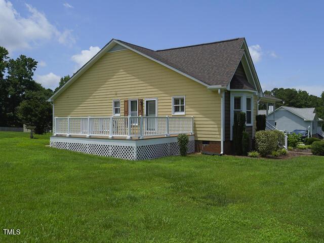 2817 Buckboard Ln, Raleigh, NC 27603 - rear view of property featuring crawl space, a deck, a lawn, and roof with shingles