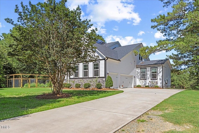 1809 Bowling Rd, Fuquay Varina, NC 27526 - view of front of house featuring concrete driveway, stone siding, a front lawn, and a garage