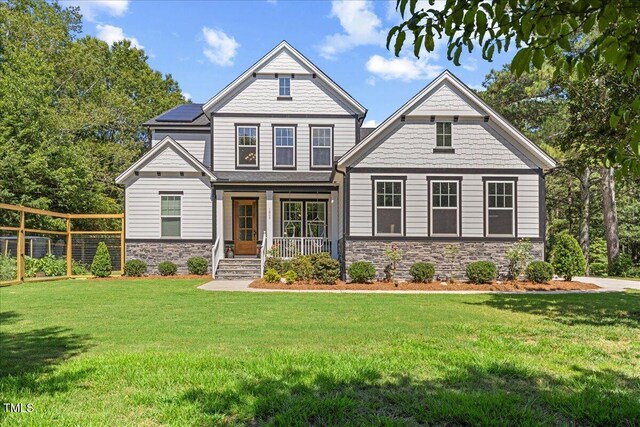 1809 Bowling Rd, Fuquay Varina, NC 27526 - craftsman house featuring stone siding, a porch, and solar panels