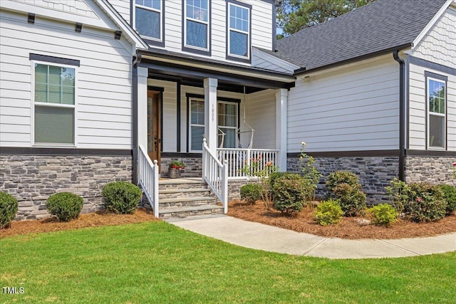 1809 Bowling Rd, Fuquay Varina, NC 27526 - property entrance with stone siding, covered porch, and a yard