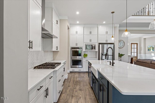 1809 Bowling Rd, Fuquay Varina, NC 27526 - kitchen with appliances with stainless steel finishes, white cabinets, recessed lighting, decorative backsplash, and wood finished floors