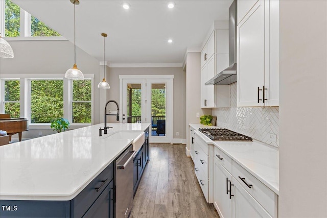 1809 Bowling Rd, Fuquay Varina, NC 27526 - kitchen with appliances with stainless steel finishes, plenty of natural light, wall chimney exhaust hood, light wood-style floors, and recessed lighting