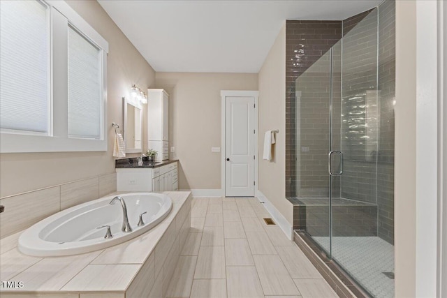 1809 Bowling Rd, Fuquay Varina, NC 27526 - bathroom featuring vanity, a shower stall, and a garden tub