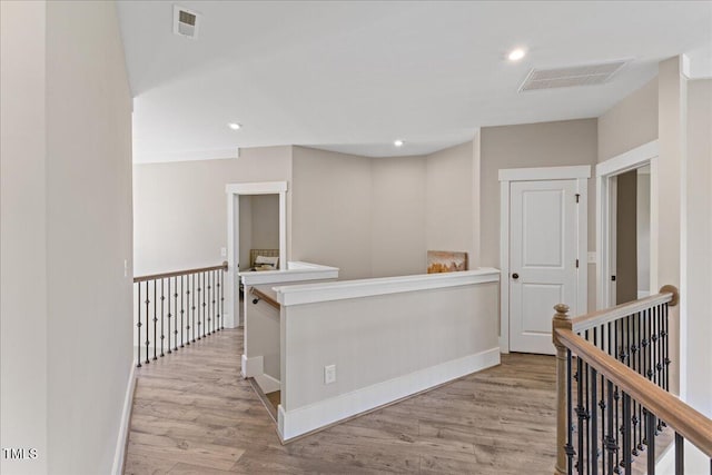 1809 Bowling Rd, Fuquay Varina, NC 27526 - hallway with light wood-style flooring, an upstairs landing, and recessed lighting
