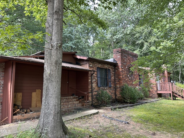194 John Mitchell Rd, Youngsville, NC 27596 - view of property exterior with a chimney and brick siding