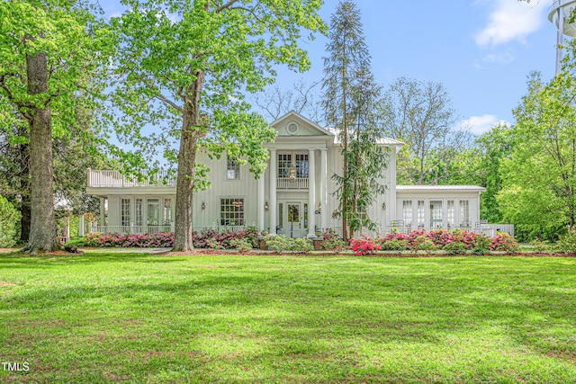 7920 E Washington St, Mebane, NC 27302 - greek revival house featuring a front yard, board and batten siding, and french doors