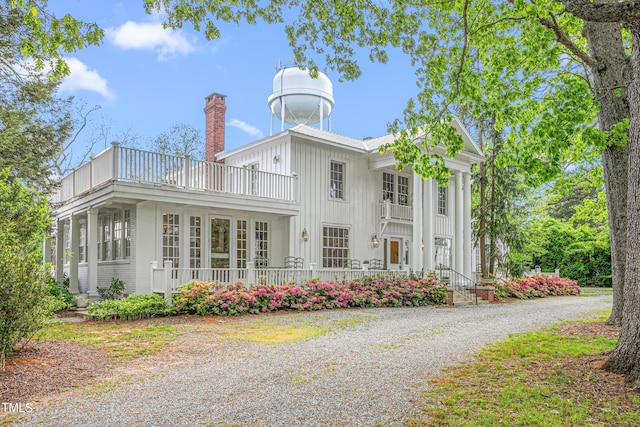 7920 E Washington St, Mebane, NC 27302 - rear view of house with a balcony, board and batten siding, and a chimney