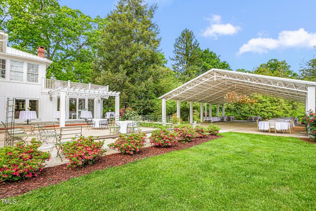 7920 E Washington St, Mebane, NC 27302 - view of grassy yard with a pergola, a patio, and a detached carport