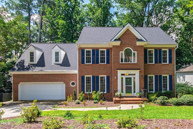 4309 Omni Pl, Raleigh, NC 27613 - view of front facade with driveway, brick siding, and an attached garage