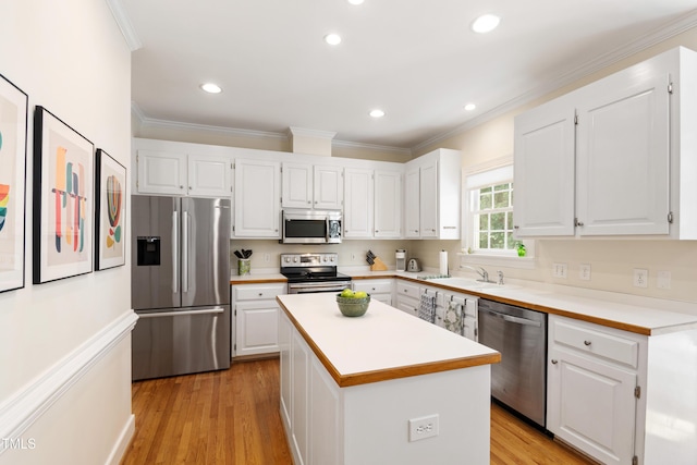 4309 Omni Pl, Raleigh, NC 27613 - kitchen featuring stainless steel appliances, crown molding, white cabinetry, light countertops, and recessed lighting