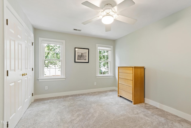 4309 Omni Pl, Raleigh, NC 27613 - unfurnished bedroom featuring multiple windows, light colored carpet, and a closet