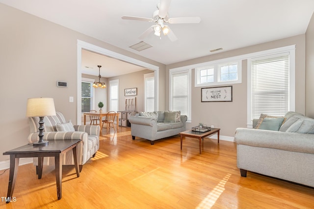 605 Bellefont Ct, Knightdale, NC 27545 - living area featuring light wood-type flooring, a chandelier, and a ceiling fan