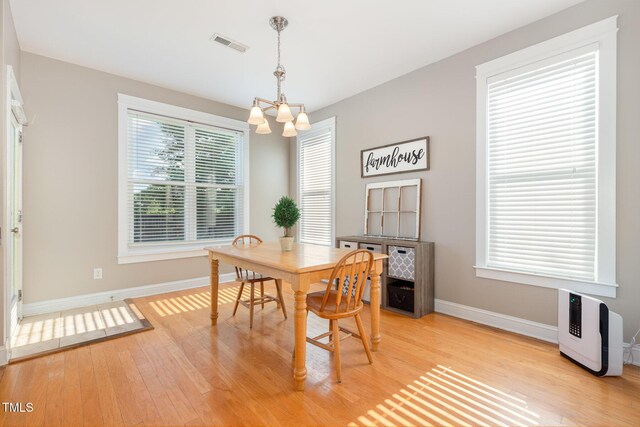 605 Bellefont Ct, Knightdale, NC 27545 - dining space featuring a chandelier and light wood finished floors