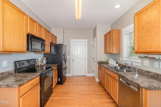 605 Bellefont Ct, Knightdale, NC 27545 - kitchen featuring black appliances, dark countertops, light wood-style flooring, and recessed lighting