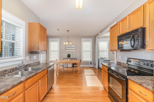 605 Bellefont Ct, Knightdale, NC 27545 - kitchen with black appliances, light wood-type flooring, a chandelier, decorative light fixtures, and dark stone counters