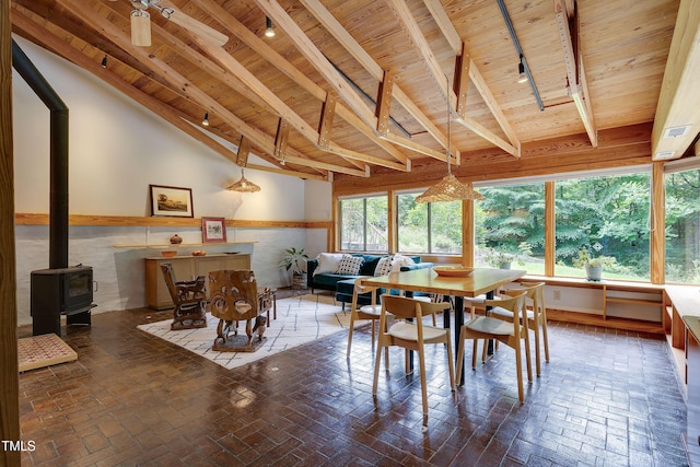 1320 Shepherd St, Durham, NC 27707 - dining space featuring a wood ceiling with exposed beams, a wood stove, brick patterned flooring, and high vaulted ceiling
