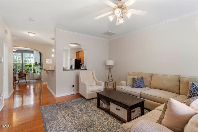 4533 Pale Moss Dr, Raleigh, NC 27606 - living area with arched walkways, ceiling fan, light wood finished floors, and ornamental molding