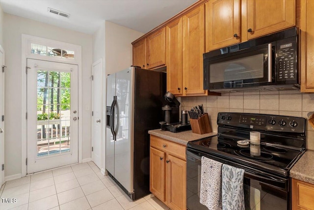 4533 Pale Moss Dr, Raleigh, NC 27606 - kitchen featuring black appliances, decorative backsplash, brown cabinets, and light tile patterned flooring