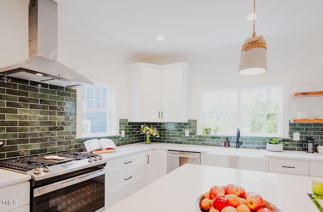 415 E Lavender Ave, Durham, NC 27704 - kitchen with appliances with stainless steel finishes, island exhaust hood, tasteful backsplash, light countertops, and white cabinets