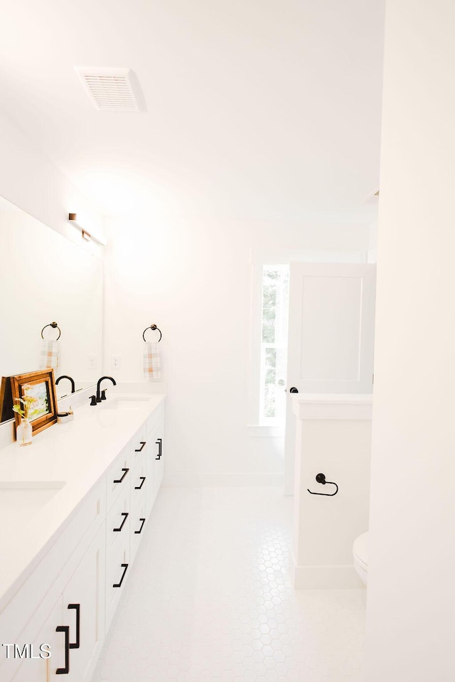 415 E Lavender Ave, Durham, NC 27704 - bathroom with double vanity and tile patterned floors