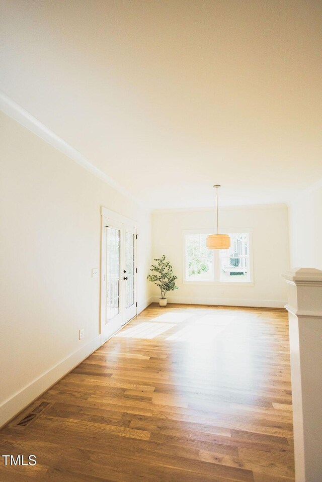 415 E Lavender Ave, Durham, NC 27704 - empty room with french doors and light wood-style floors