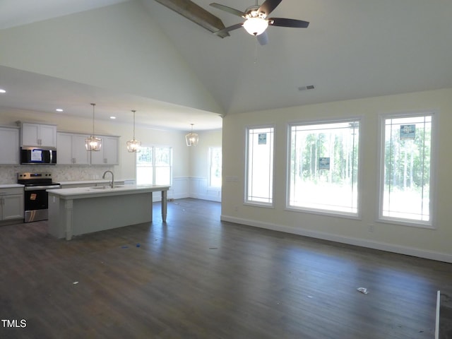 776 Shadetree Rd, Benson, NC 27504 - kitchen featuring stainless steel appliances, open floor plan, light countertops, high vaulted ceiling, and a kitchen island with sink