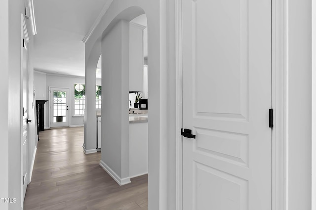 4536 Sugarbend Way, Raleigh, NC 27606 - hall with arched walkways, crown molding, and wood finished floors