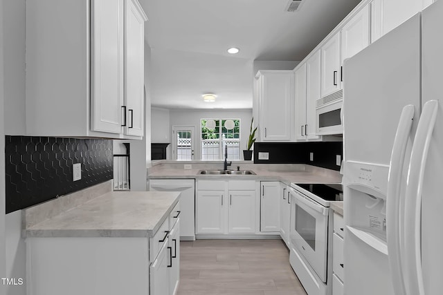 4536 Sugarbend Way, Raleigh, NC 27606 - kitchen with white appliances, recessed lighting, white cabinets, light countertops, and backsplash